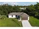 Lovely single Gathering home featuring an attached two car garage and mature landscaping in a peaceful setting at 3588 Erie Ct, North Port, FL 34287