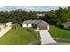 An inviting single-story home with a well-kept lawn and a convenient two-car garage at 3588 Erie Ct, North Port, FL 34287