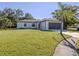 A charming single story house with a well-manicured lawn and a dark brown two car garage at 3588 Erie Ct, North Port, FL 34287