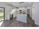 Modern kitchen featuring white cabinets, stainless steel appliances, and gray flooring at 3588 Erie Ct, North Port, FL 34287