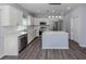 Bright kitchen with white cabinets, subway tile backsplash, and stainless steel appliances at 3588 Erie Ct, North Port, FL 34287