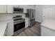 Close up of kitchen featuring stainless steel appliances and white cabinetry at 3588 Erie Ct, North Port, FL 34287