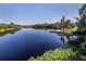 Expansive lake view featuring a dock and lush shoreline, offering a peaceful retreat at 3588 Erie Ct, North Port, FL 34287