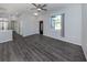 Living room with modern gray flooring, ceiling fan, and a large window at 3588 Erie Ct, North Port, FL 34287