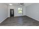 Living room with modern gray flooring, a window with blinds, and an ornate front door at 3588 Erie Ct, North Port, FL 34287