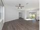 Bright and airy living room featuring wood flooring and a ceiling fan at 3588 Erie Ct, North Port, FL 34287