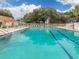 A large, inviting swimming pool with lounge chairs and umbrellas, perfect for relaxation at 3588 Erie Ct, North Port, FL 34287