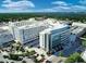 Aerial shot of Sarasota Memorial Hospital with its modern architecture, surrounded by lush green landscaping and city streets at 3616 Lalani Blvd, Sarasota, FL 34232