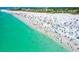 Bustling Siesta Key Beach with a crowd of people enjoying the white sand and clear turquoise water from an aerial perspective at 3616 Lalani Blvd, Sarasota, FL 34232