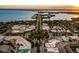 Overhead view of a coastal neighborhood with waterfront access and lush green spaces with the bay on the horizon at 3616 Lalani Blvd, Sarasota, FL 34232