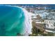 Aerial view of Siesta Key beach, showcasing the shoreline, turquoise waters, and nearby buildings under a sunny sky at 3616 Lalani Blvd, Sarasota, FL 34232