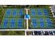 Aerial view of multiple blue and green pickleball courts with players enjoying games on a sunny day at 3616 Lalani Blvd, Sarasota, FL 34232