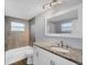 Updated bathroom features new vanity with granite counters and modern lighting at 3616 Lalani Blvd, Sarasota, FL 34232