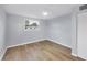 Well lit bedroom featuring new floors, a closet, and multiple windows at 3616 Lalani Blvd, Sarasota, FL 34232