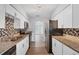 Well-appointed kitchen boasting stainless steel appliances, granite countertops, and ample cabinet space for culinary enthusiasts at 3616 Lalani Blvd, Sarasota, FL 34232