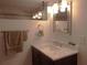 Bathroom with a marble countertop, towel rack, and lots of bright lighting from the fixtures at 373 Longwood Dr, Venice, FL 34285