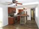 Open kitchen layout with island counter, stainless steel appliances, and wood laminate flooring at 373 Longwood Dr, Venice, FL 34285