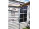 Exterior shower on home's side, featuring outdoor surfboard rack with hooks at 373 Longwood Dr, Venice, FL 34285