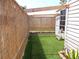 Outdoor shower area with artificial turf and lattice privacy, next to home's exterior at 373 Longwood Dr, Venice, FL 34285