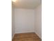Small room with wood-look floors and all white walls, ready to be converted to your needs at 373 Longwood Dr, Venice, FL 34285