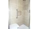 Shower with light tan and brown tile, a grab bar, a seat, and a storage niche at 373 Longwood Dr, Venice, FL 34285