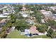 Aerial view of the property showcasing the house, yard, and surrounding neighborhood near the water at 413 Valencia Rd, Venice, FL 34285