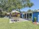 Enjoy this backyard with a patio, table and chairs, deck and hot tub under a mature shade tree at 413 Valencia Rd, Venice, FL 34285