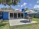 View of outdoor patio, backyard and house featuring sliding glass doors at 413 Valencia Rd, Venice, FL 34285
