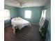 Bright bedroom with modern floors, a ceiling fan, natural light, and closet space at 413 Valencia Rd, Venice, FL 34285