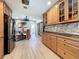 Spacious kitchen with stainless steel appliances, wood cabinetry, and stylish backsplash at 413 Valencia Rd, Venice, FL 34285