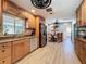 Modern kitchen with wood cabinets, stainless steel appliances, and a dining area at 413 Valencia Rd, Venice, FL 34285