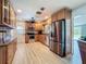 Well-equipped kitchen with stainless steel appliances, wood cabinets, and stone backsplash at 413 Valencia Rd, Venice, FL 34285