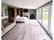 Spacious living room with wood flooring, a fireplace, and sliding glass doors to backyard at 413 Valencia Rd, Venice, FL 34285