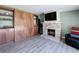 Living room featuring light wood floors, built-in cabinets, fireplace and TV at 413 Valencia Rd, Venice, FL 34285