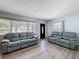 Bright living room with large windows, comfortable seating, and modern flooring at 413 Valencia Rd, Venice, FL 34285
