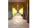Covered walkway with arches and lights, featuring benches and trash receptacles at 413 Valencia Rd, Venice, FL 34285