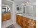 Bathroom with double sinks, granite countertop, and a mirror, providing a functional space at 418 Cerromar Ct # 158, Venice, FL 34293