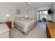 Bright bedroom featuring a ceiling fan, wood-look flooring, and sliding glass doors to the outdoor patio at 418 Cerromar Ct # 158, Venice, FL 34293