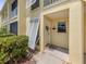 Charming condo entrance featuring a decorative wreath on the front door and well-maintained landscaping at 418 Cerromar Ct # 158, Venice, FL 34293