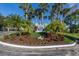 Westchester Gardens entrance sign with lush landscaping and mature palms in a well-maintained community at 418 Cerromar Ct # 158, Venice, FL 34293