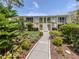 Charming two-story condo building with well-maintained landscaping and inviting walkway at 418 Cerromar Ct # 158, Venice, FL 34293