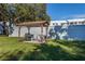 Outdoor grilling area offers a barbecue, seating beneath a covered gazebo, and ample green space for community residents at 418 Cerromar Ct # 158, Venice, FL 34293