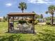 Community grilling area with seating, BBQ, set amid lush landscaping, offers outdoor enjoyment for residents at 418 Cerromar Ct # 158, Venice, FL 34293