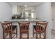 Kitchen features granite countertops, white cabinets, stainless appliances, and an eat-in bar for casual dining at 418 Cerromar Ct # 158, Venice, FL 34293