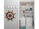 Efficient laundry room with modern appliances, shelving, and decorative elements at 418 Cerromar Ct # 158, Venice, FL 34293