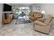 Inviting living room featuring tile flooring, a leather sofa, recliner, and access to the outdoor space at 418 Cerromar Ct # 158, Venice, FL 34293