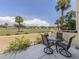 Outdoor patio with seating and a view, surrounded by lush greenery and a well-maintained lawn at 418 Cerromar Ct # 158, Venice, FL 34293
