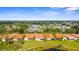 Picturesque community with red-tiled roofs, lush landscaping, and a tranquil pond, offering a serene living environment at 4378 Summertree Rd, Venice, FL 34293