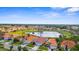 Expansive aerial view showcasing a community with beautiful homes surrounding a tranquil lake and lush greenery at 4378 Summertree Rd, Venice, FL 34293
