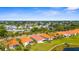 Community with homes, red tile roofs, landscaping, and mature trees, offering a serene neighborhood setting at 4378 Summertree Rd, Venice, FL 34293
